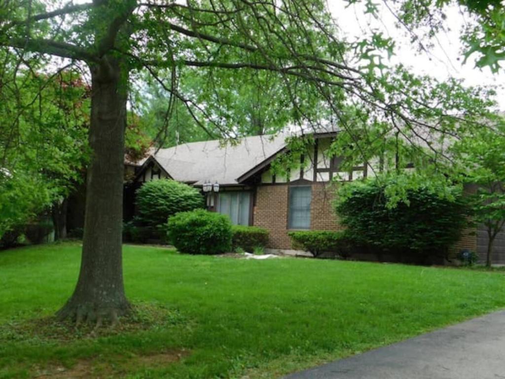 a brick house with a tree in the yard at Office + 5 BR, Movie Theater , Creve Coeur -10 Sleep surface in Creve Coeur