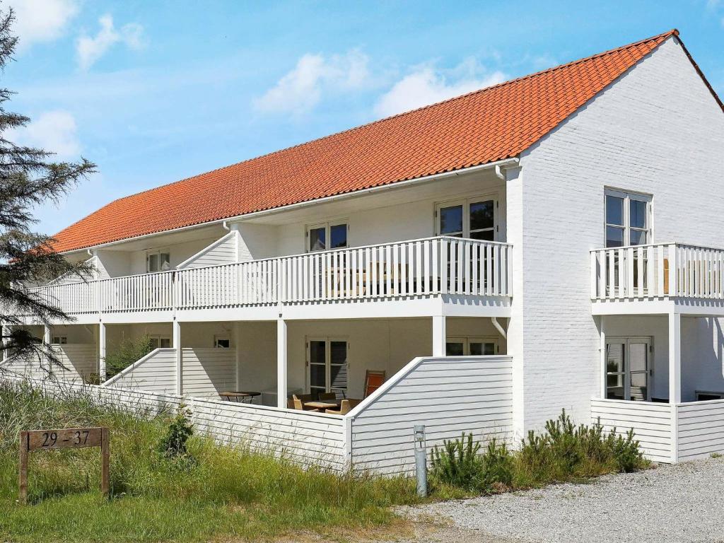スケーエンにあるApartment Skagenのオレンジ色の屋根の白い家