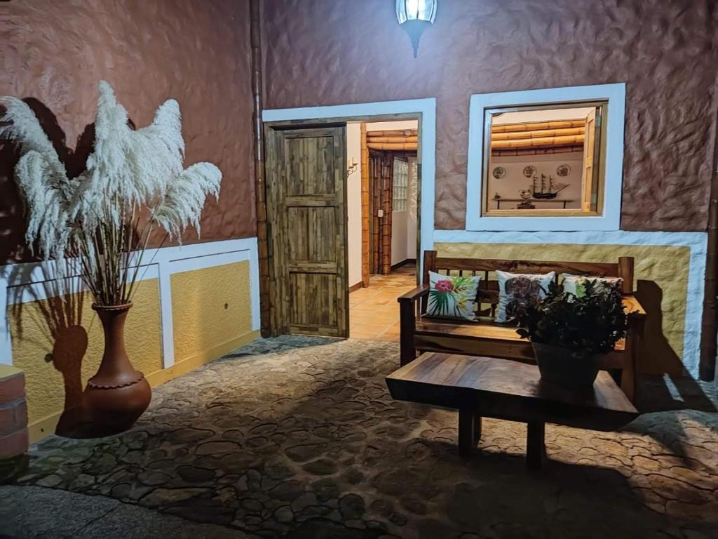 um quarto com um sofá, uma mesa e um espelho em La Casona Del Retiro em Medellín