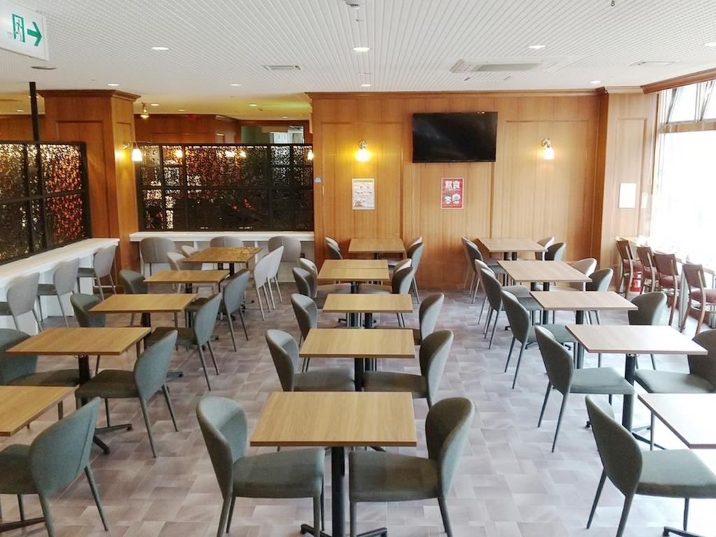 a restaurant with rows of tables and chairs at Hotel Abest Naha Kokusaidori in Naha