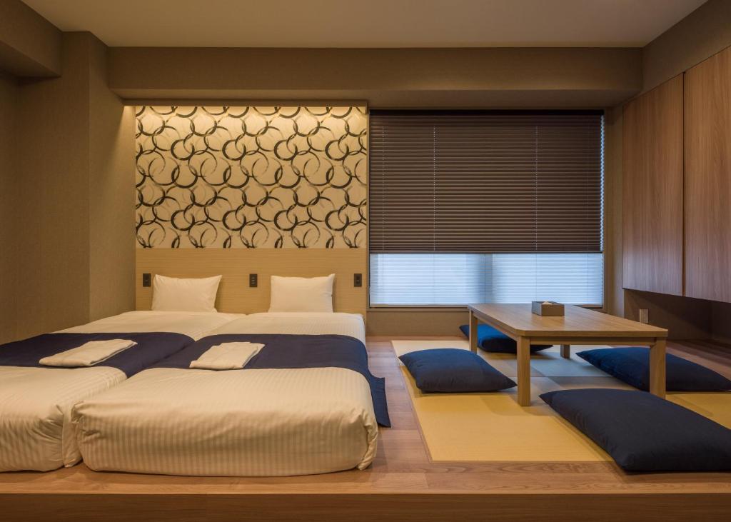 Postel nebo postele na pokoji v ubytování KOKO HOTEL Residence Asakusa Kappabashi