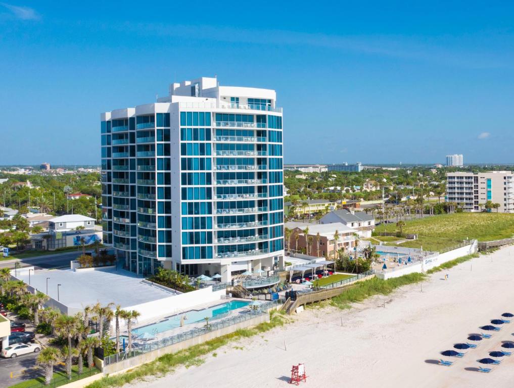 an aerial view of a tall building next to a beach at Max Beach Resort in Daytona Beach