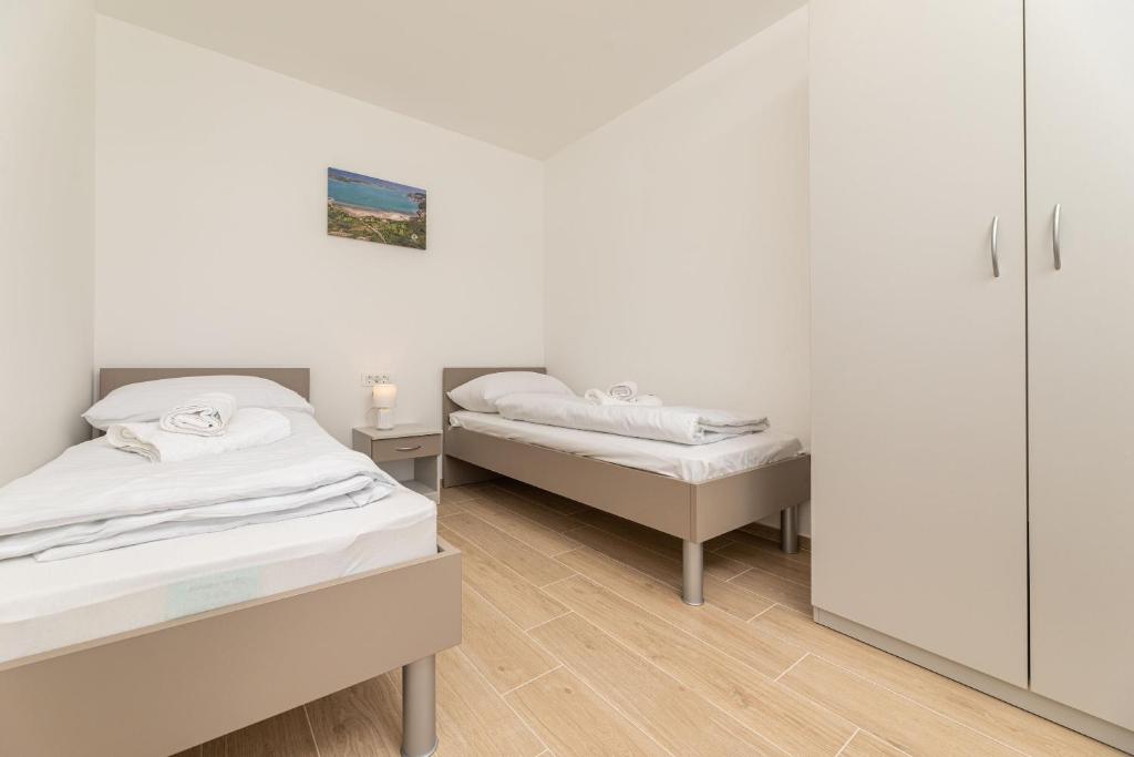 Кровать или кровати в номере Apartments Sucic 2