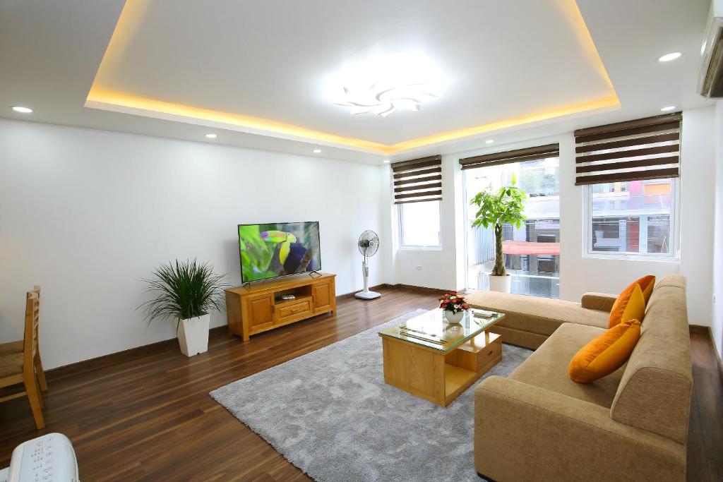 a living room with a couch and a tv at Sumitomo luxury apartment hotel near Lotte in Hanoi