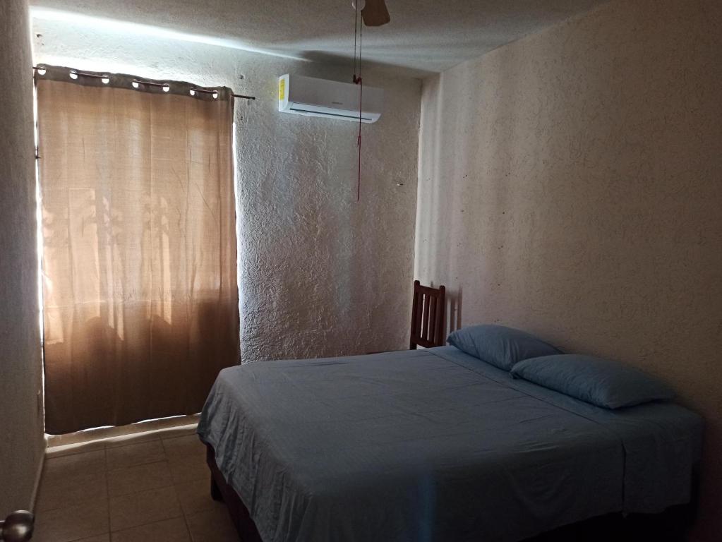 Una cama o camas en una habitación de Casita Mahahual, Grand Costa Maya