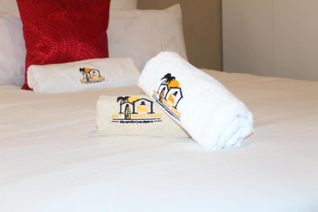 a hotel room with towels on a bed at Unit G Guest House in Ga-Mothiba