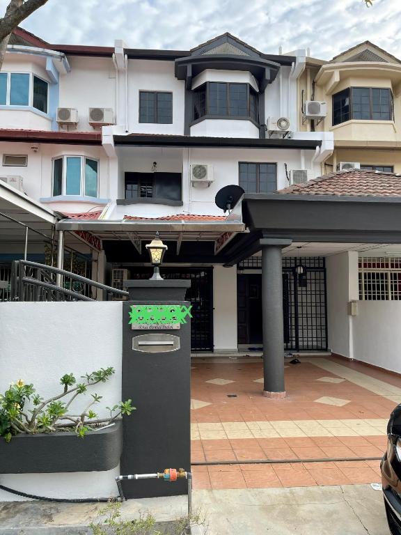 a house with a parking meter in front of it at Villa Prisha in Bayan Lepas