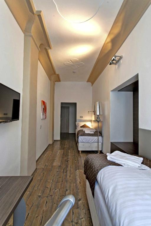 Postel nebo postele na pokoji v ubytování Hotel U Tří hrušek suites & apartments