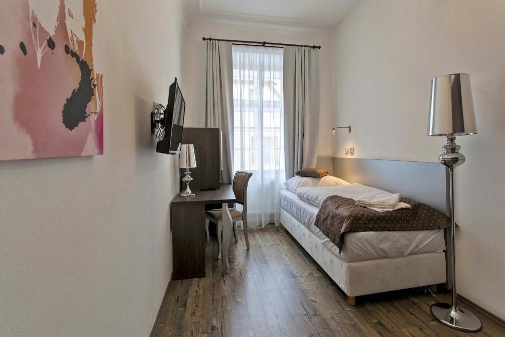 Postel nebo postele na pokoji v ubytování Hotel U Tří hrušek suites & apartments