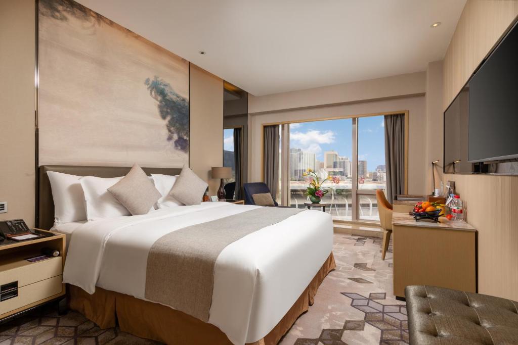 Postel nebo postele na pokoji v ubytování Zhuhai Longzhuda International Hotel