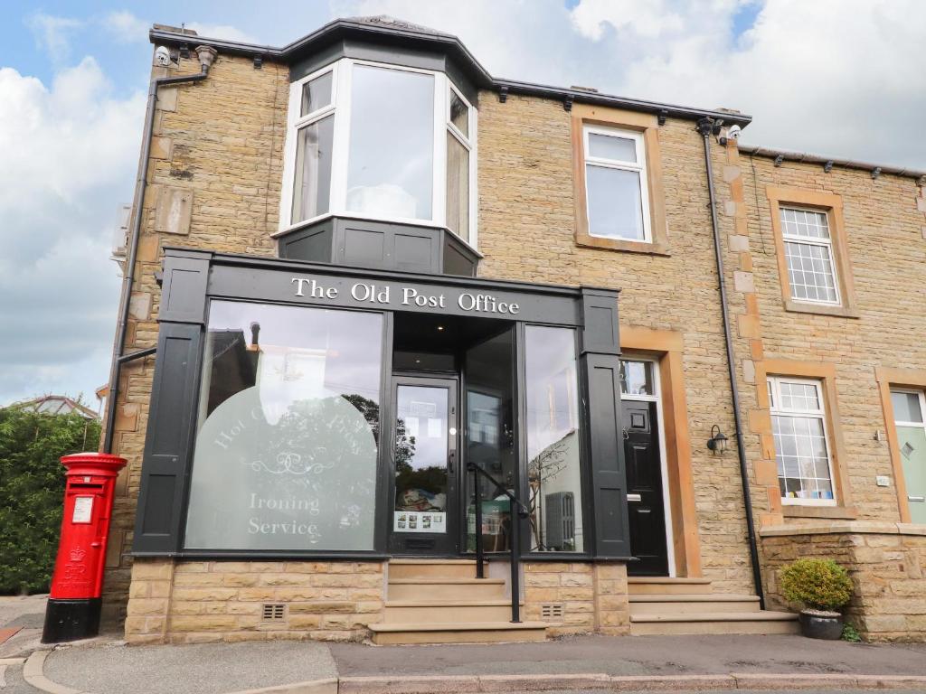 a store front of a brick building at The Old Post Office in Burnley