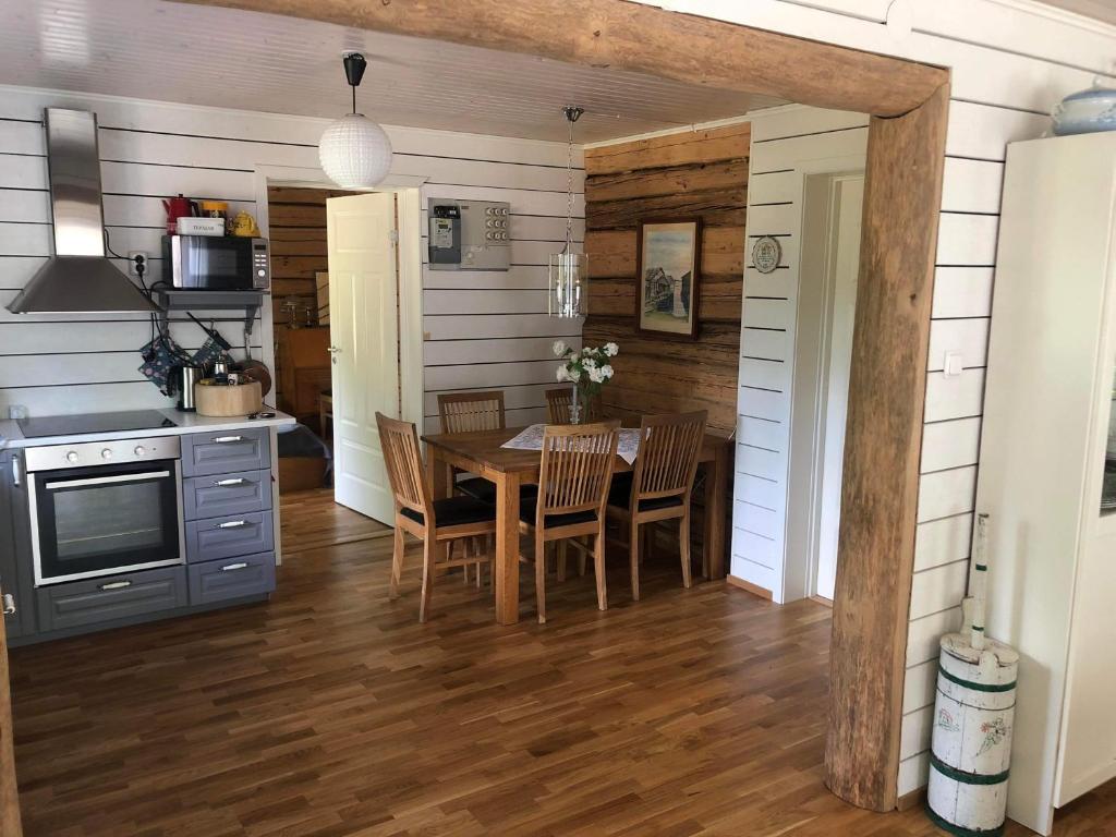 a kitchen and dining room with a table and chairs at Stor Familjegård i bra läge in Finström