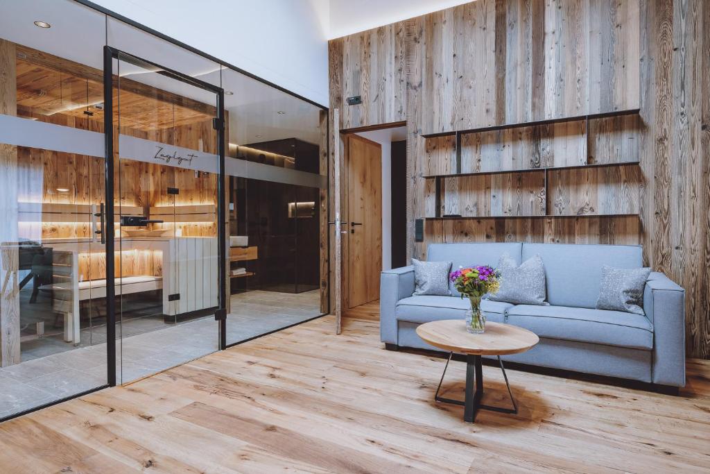 a living room with a couch and a table at Bergdorf Hotel Zaglgut in Kaprun