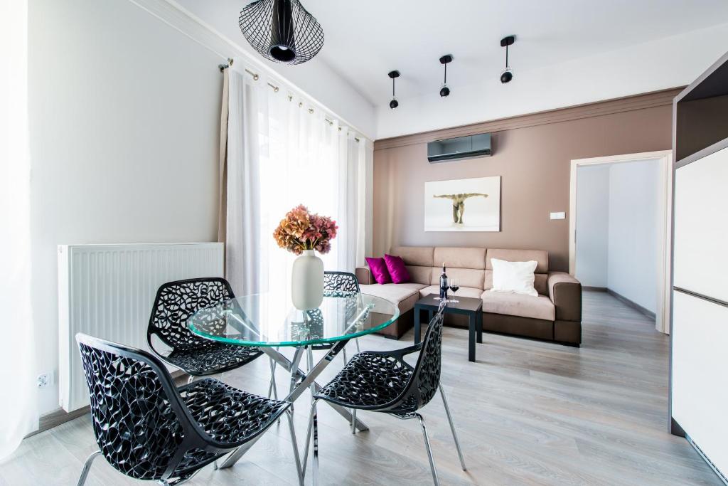 a living room with a glass table and chairs at Centrum Superior Suites in Białystok