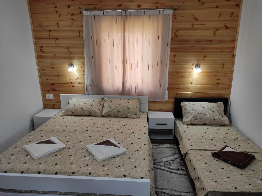 a bedroom with two beds and a window at Apartments Nemanja in Žabljak