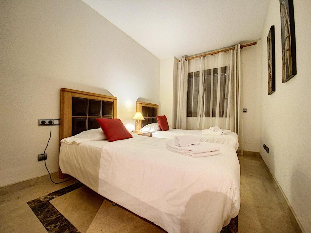 A bed or beds in a room at Lovely apartment with pool & sea views - Marina Del Castillo 2129
