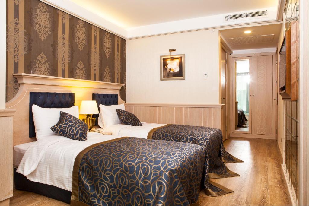A bed or beds in a room at The Conforium Hotel İstanbul