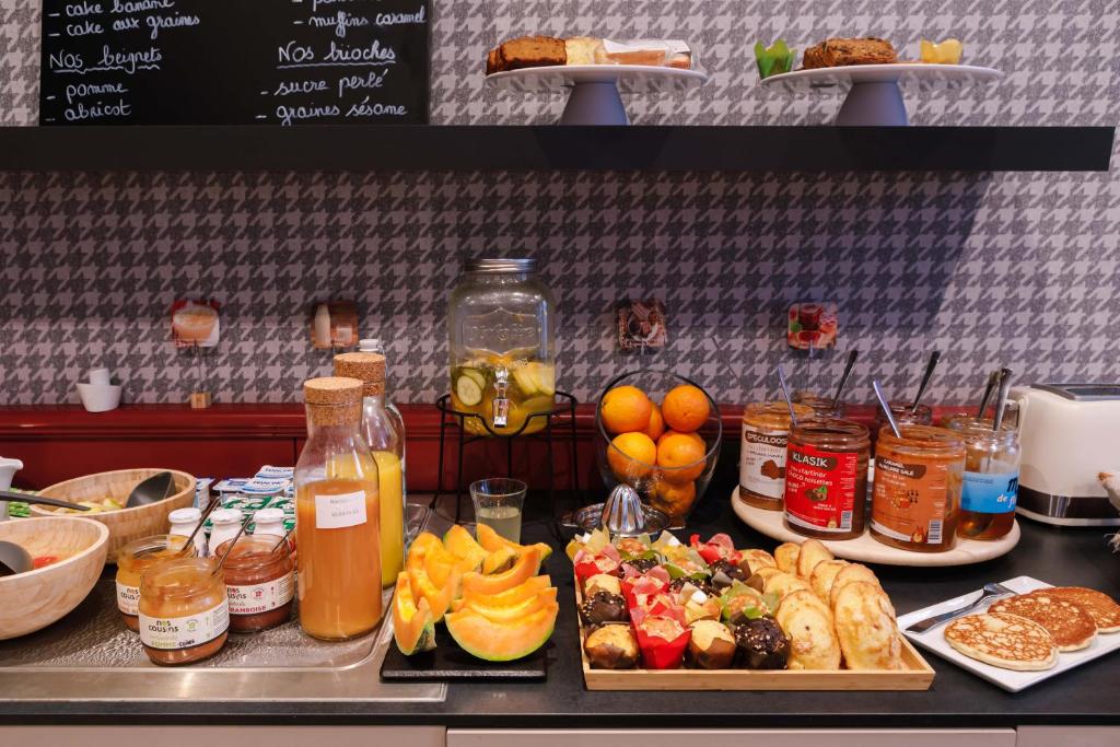 a counter with many different types of food and drinks at Hôtel de Noailles in Lyon