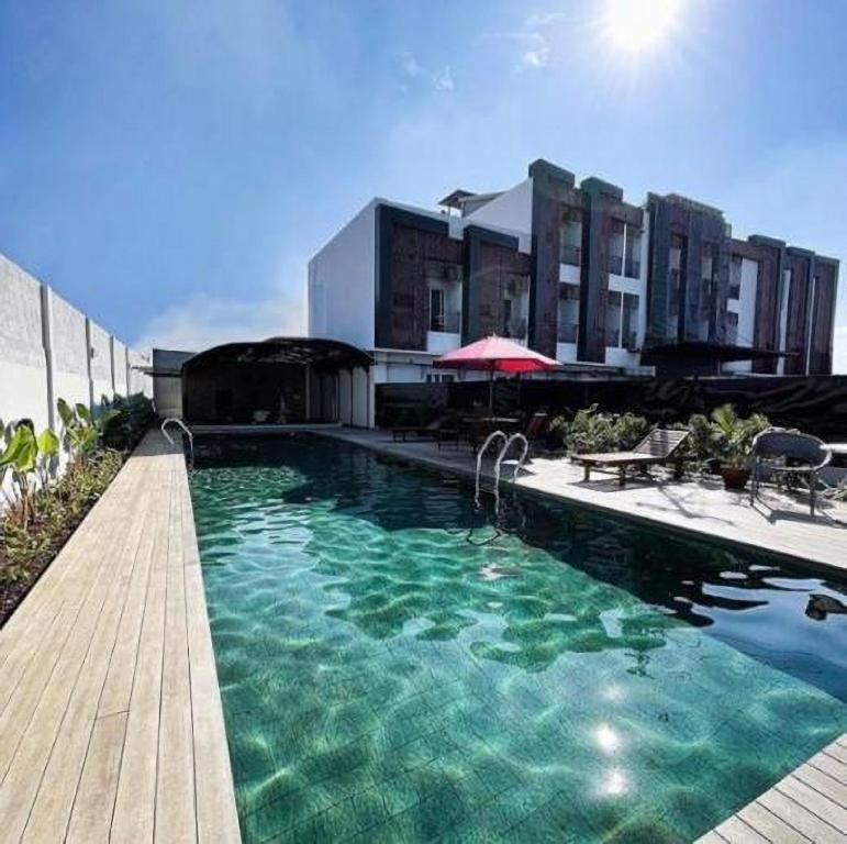 een groot zwembad voor een gebouw bij Ra Inn Kemang in Jakarta