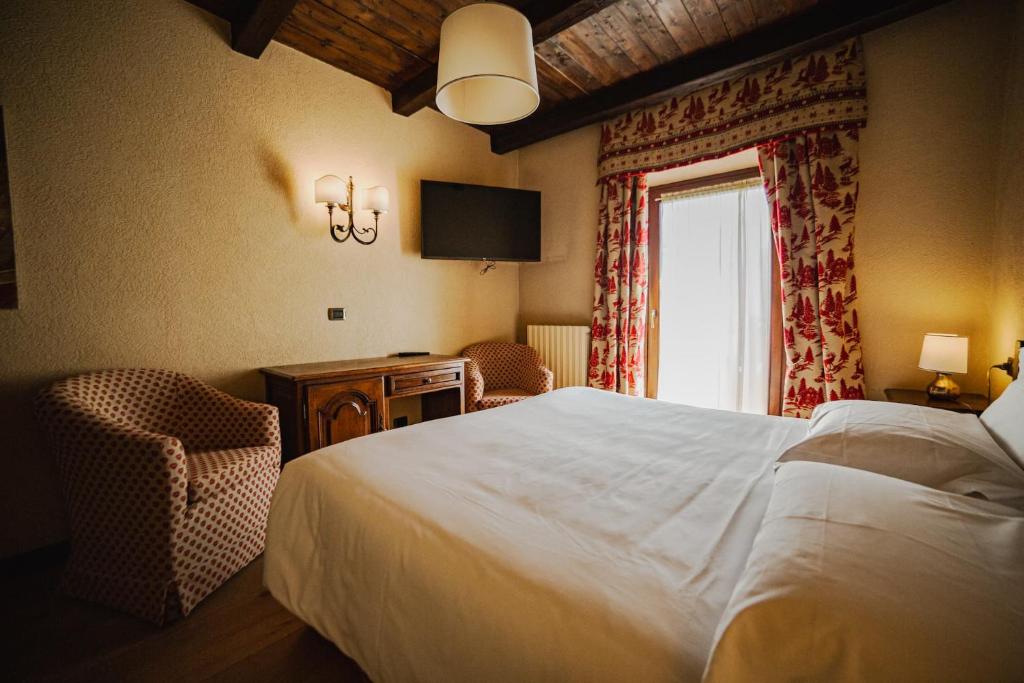 Postel nebo postele na pokoji v ubytování Hotel Jumeaux