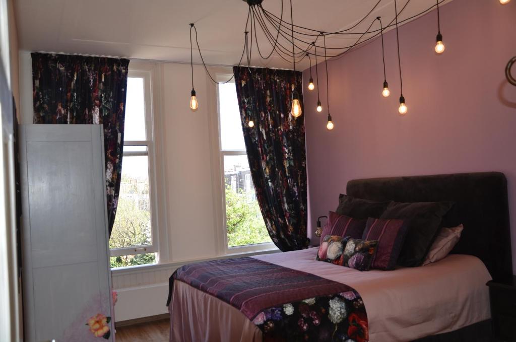 a bedroom with a bed and a window at Prins Maurits in The Hague