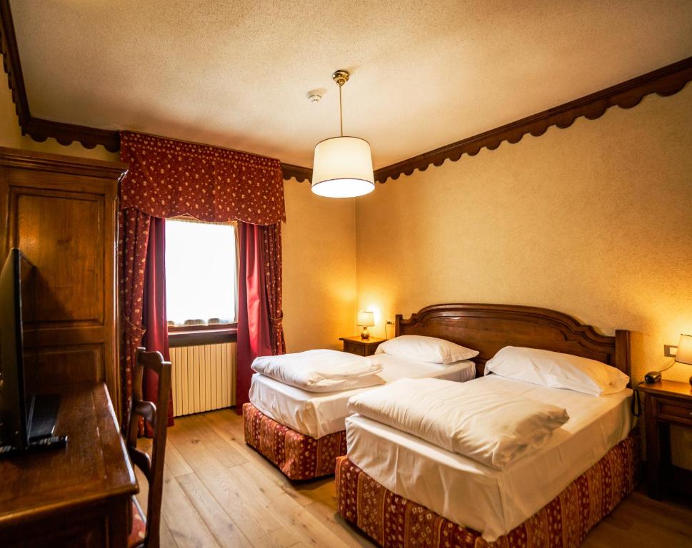 Postel nebo postele na pokoji v ubytování Hotel Jumeaux