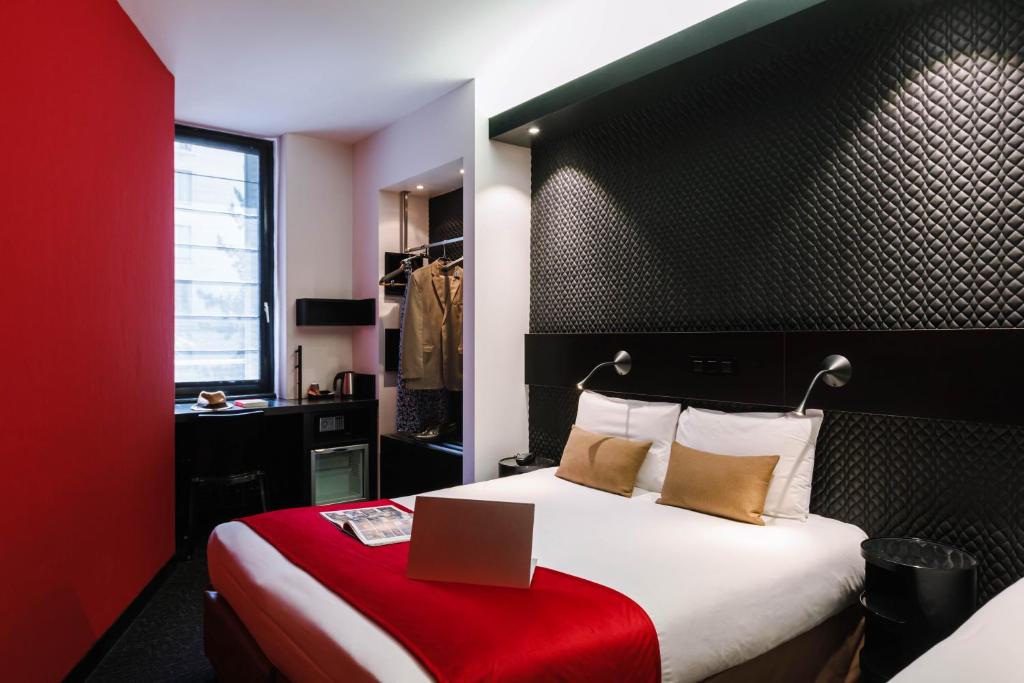 a hotel room with a bed with a box on it at Hôtel de Noailles in Lyon