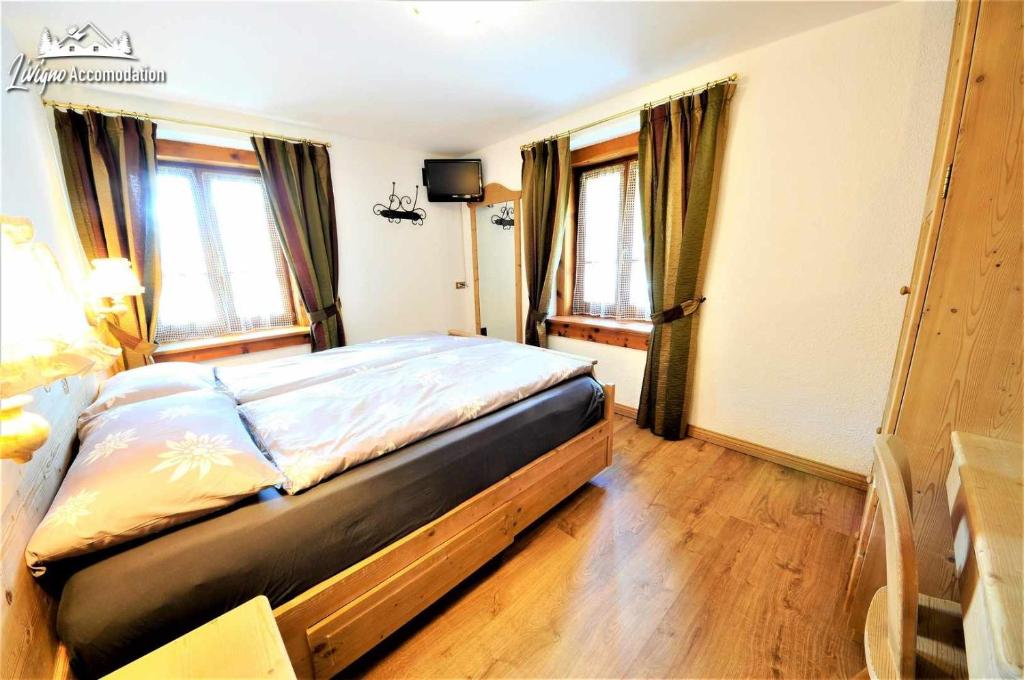 Ένα ή περισσότερα κρεβάτια σε δωμάτιο στο Miky's apartment by Livigno Accomodation