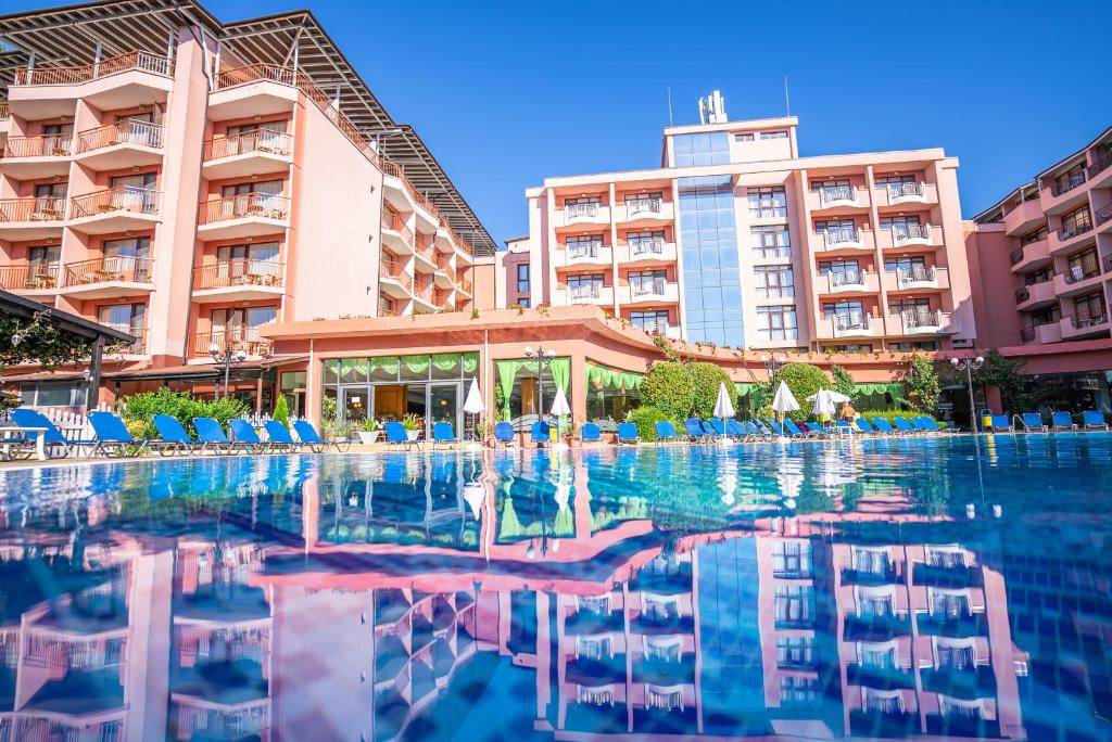 a swimming pool in front of a hotel at Izola Paradise Hotel - All Inclusive in Sunny Beach