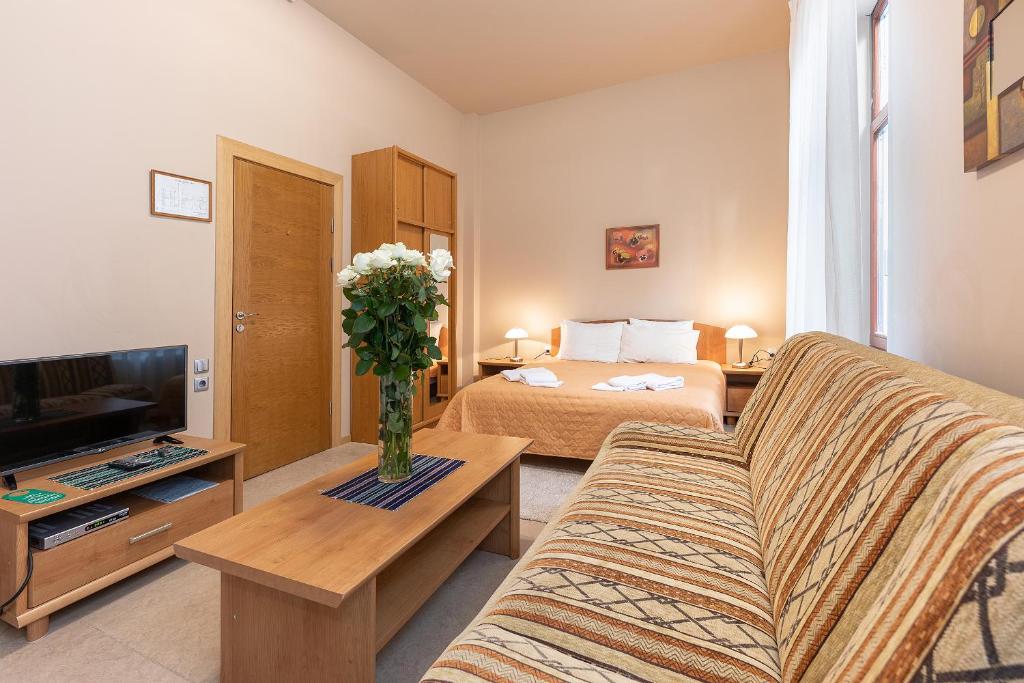 - un salon avec un canapé et un lit dans l'établissement Valensija Studio Apartment Hotel, à Jurmala