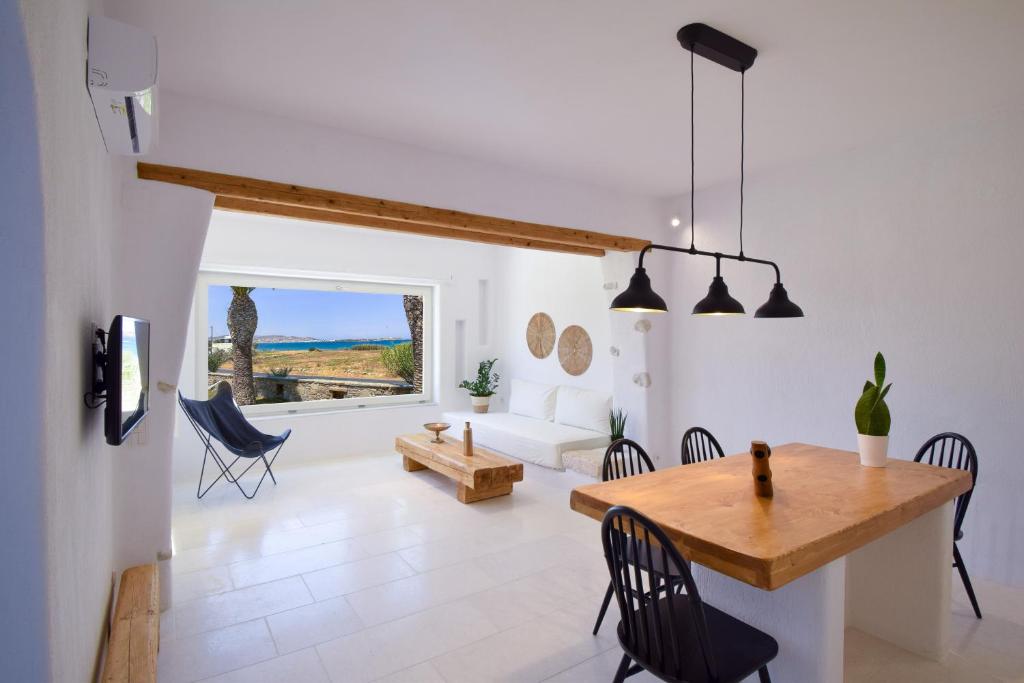 a kitchen and living room with a table and chairs at SUNSET POUNDA LUXURY VERSION in Pounda