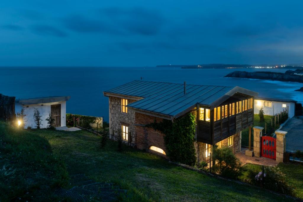 a house on a hill with a view of the water at Perfect for Sea Lovers in Arnao