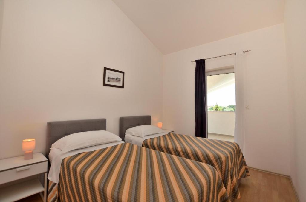 Posteľ alebo postele v izbe v ubytovaní Apartments Pool