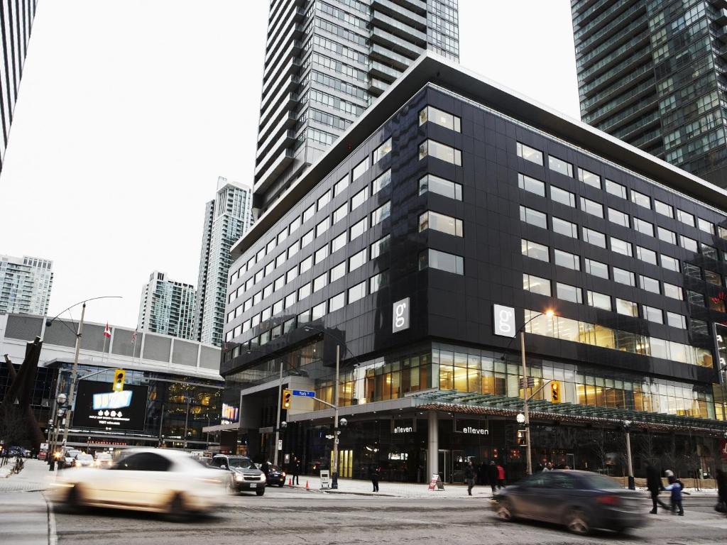 a large black building in a city with cars at Le Germain Hotel Maple Leaf Square in Toronto
