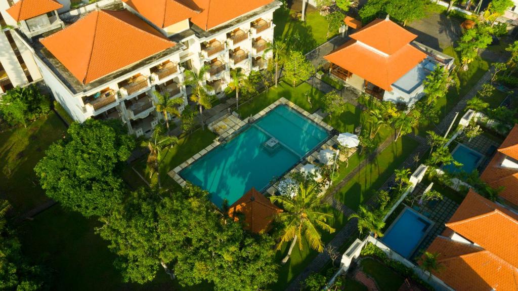 an overhead view of a resort with a swimming pool and trees at Kusuma Resort Seminyak in Seminyak