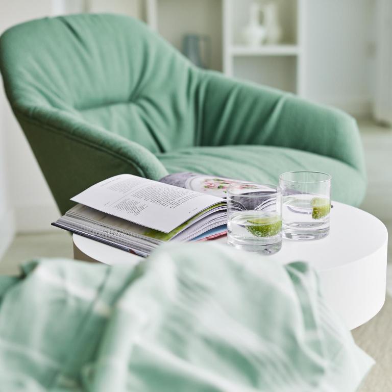 a table with glasses and a book on a chair at St Moritz Hotel and Cowshed Spa in Polzeath