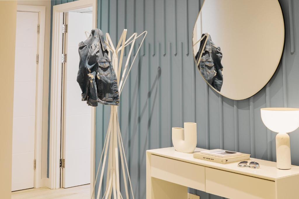 a living room with a mirror and a table at St Moritz Hotel and Cowshed Spa in Polzeath