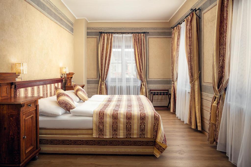 a bedroom with a bed and a window at The Charles in Prague