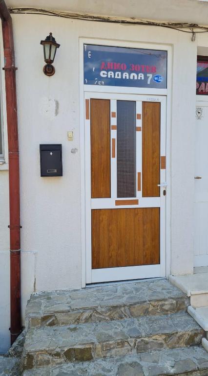 a wooden door on the side of a building at Sadala Guest House in Nesebar