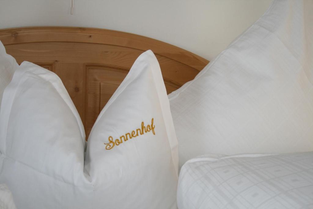 A bed or beds in a room at Pension Sonnenhof