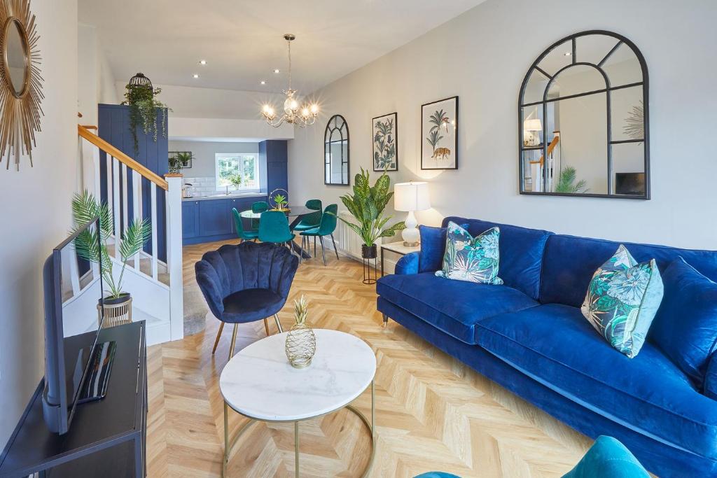 a living room with a blue couch and a table at Host & Stay - Prospect Hill Apartments in Whitby