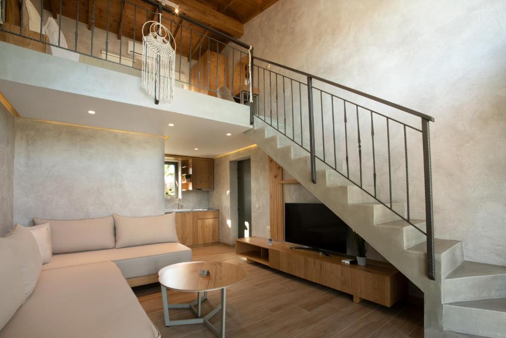 a living room with a couch and a staircase at Kallithea Village hotel in Kallithea Halkidikis