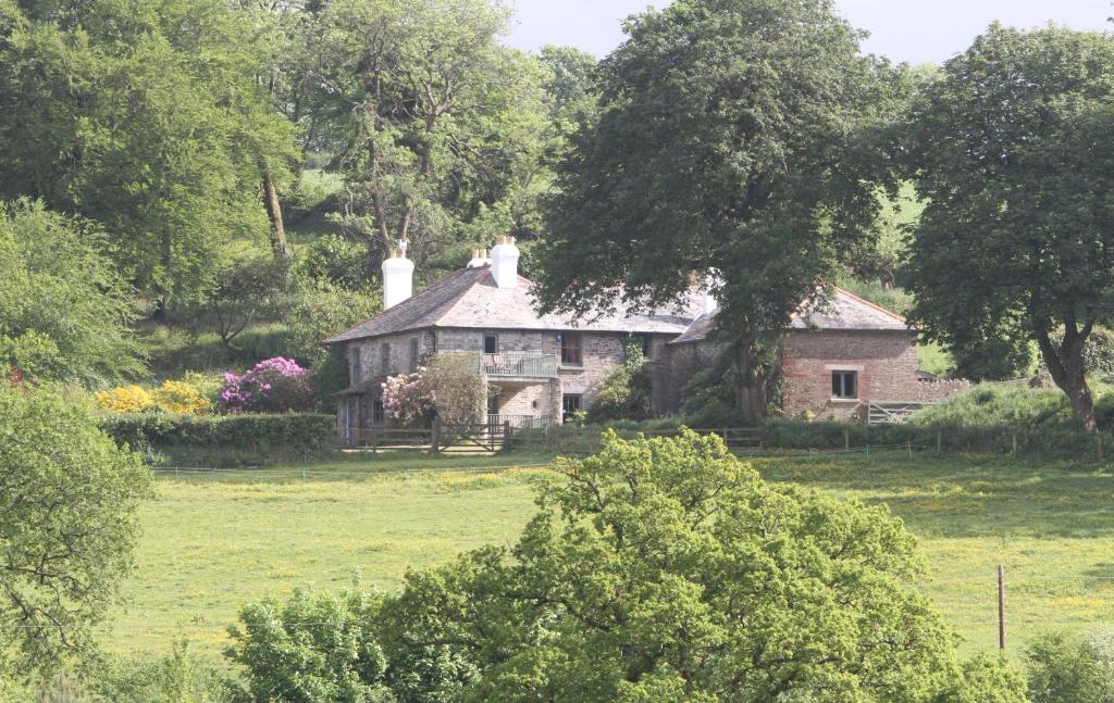 een oud huis in het midden van een veld bij Devon Country Paradise in Tavistock