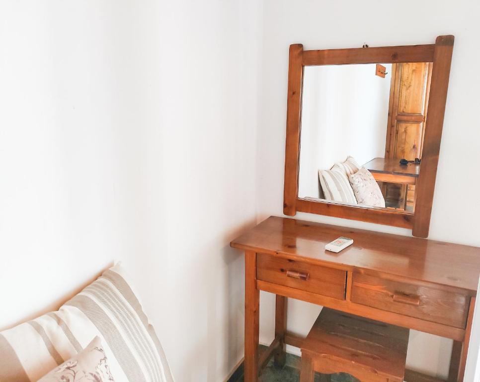 a dressing table with a mirror and a wooden dresser at Anna Garden Sidari in Sidari