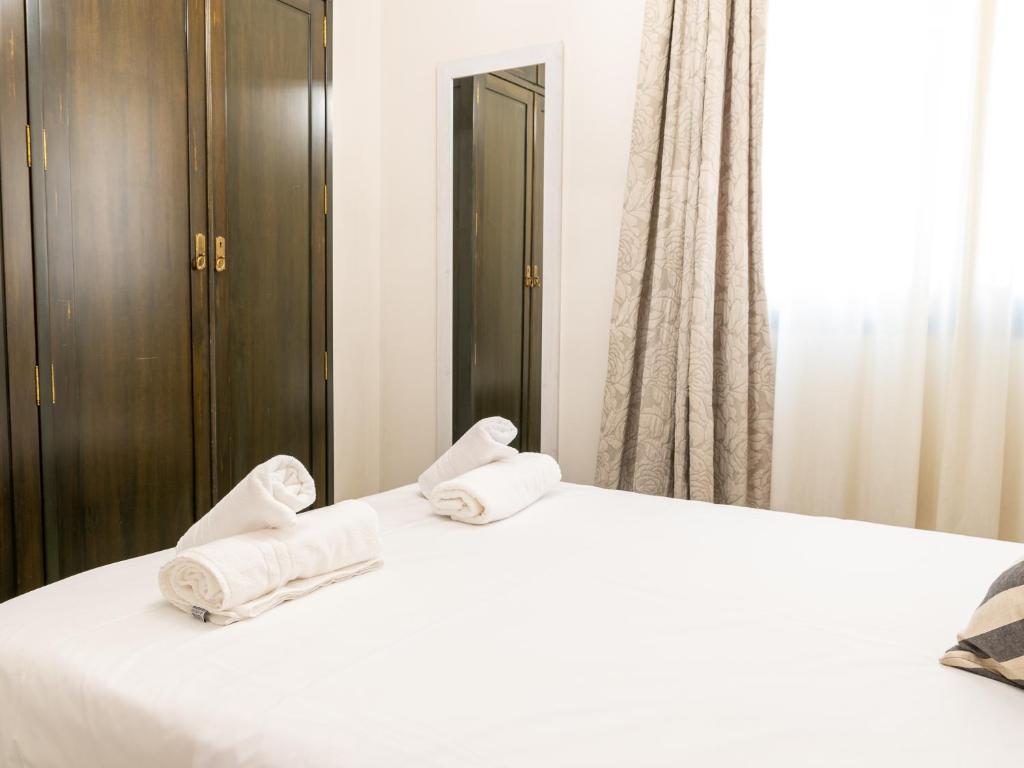 Posteľ alebo postele v izbe v ubytovaní Tejares Suite Córdoba
