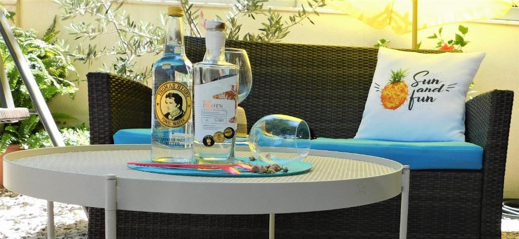 a table with two bottles of wine and a glass at Apartment Dalmatia Ketty in Makarska