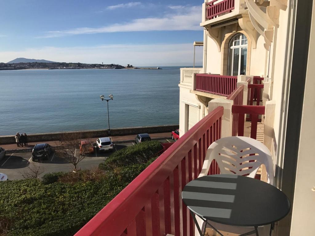 a balcony with a chair and a view of the ocean at Résidence Thiers Golf 1 -Charmant studio face à la baie in Saint-Jean-de-Luz