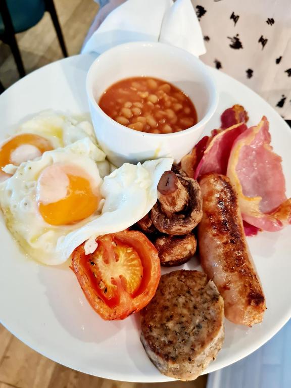 a plate of breakfast food with eggs bacon beans and beans at St Moritz Hotel and Cowshed Spa in Polzeath