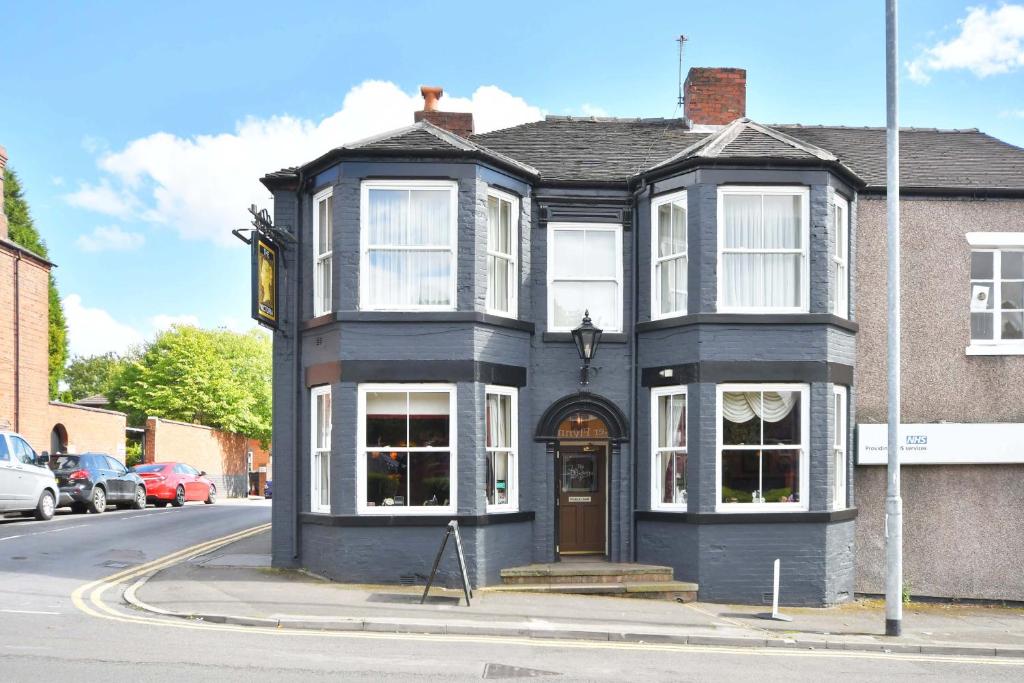 a black building on the corner of a street at The Victoria in Newcastle under Lyme