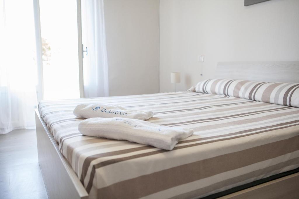 Postel nebo postele na pokoji v ubytování BluRiva Hotel